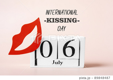 Red lips, calendar isolated on pink background 06 July - International Kissing Day concept Greeting holiday card. 89848487