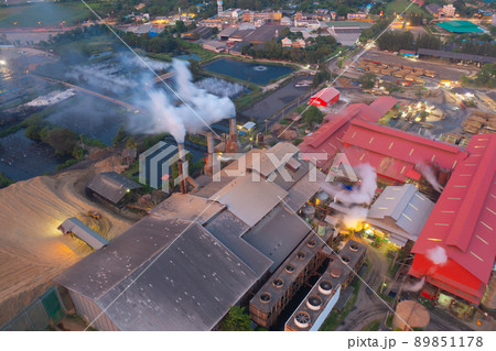 Aerial view of factory industry with smoke and toxic air from chimney in energy and pollution environment concept with city town landscape background. Aerial view of factory industry with smoke and toxic air from chimney in energy and pollution environment concept with city town landscape background. 89851178