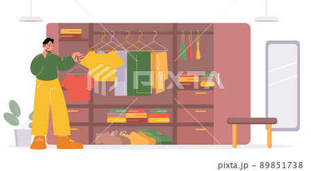 Man choose t-shirt in wardrobe Man choose t-shirt in wardrobe 89851738