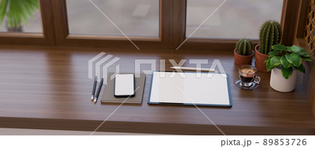Workspace with a tablet mockup, smartphone and decor plants on modern classic wood tabletop 89853726