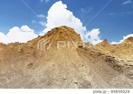Heap of earth sand and clay at the construction site against the sky. Earthworks at the construction site. 89856029