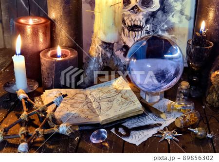 Wicca, esoteric and occult still life with vintage magic objects on witch table altar for mystic rituals and fortune telling. Halloween and gothic concept Wicca, esoteric and occult still life with vintage magic objects on witch table altar for mystic rituals and fortune telling. Halloween and gothic concept 89856302