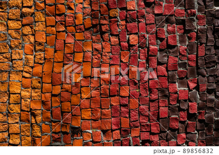 Mosaic of small red, yellow, brown, orange, bright pebbles. 89856832