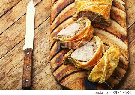 Wellington pork, pork tenderloin baked with mushrooms in puff pastry. 89857630