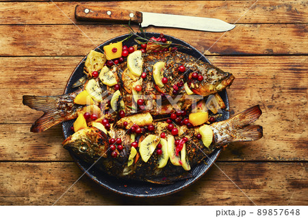 Delicious carp grilled with kiwi and mango. Delicious carp grilled with kiwi and mango. 89857648