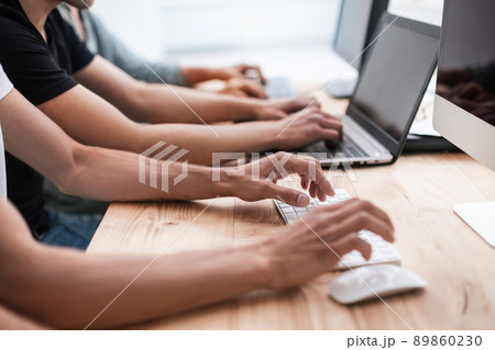 close up. a group of employees work on their computers 89860230