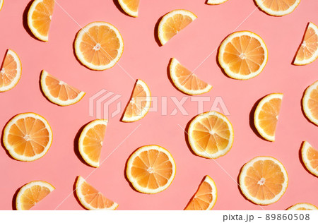 Pattern of many sliced lemons and oranges on a trendy bright pink background. Flat lay, top view. Summer freshness, detox, antioxidants, healthy lifestyle concept 89860508