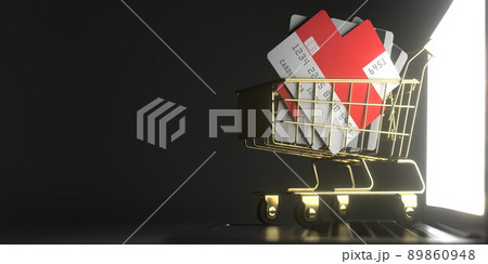 Shopping cart full of credit cards mockups with flags of Indonesia on the laptop. 3D rendering Shopping cart full of credit cards mockups with flags of Indonesia on the laptop. 3D rendering 89860948