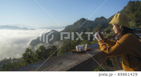 Asian traveller with camera take photo for a fog on a mountain at Japo village  89861429