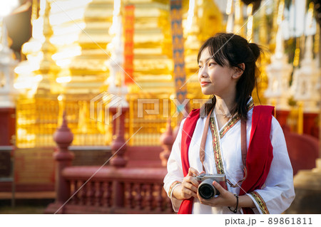 Asian traveller with camera on hand and vintage costume walking in Chiang mai city 89861811