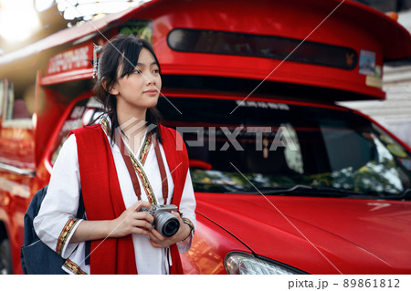 Asian traveller with camera on hand and vintage costume 89861812