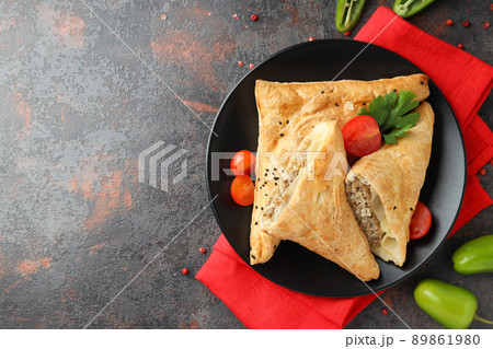 Concept of tasty food with samsa on dark textured background Concept of tasty food with samsa on dark textured background 89861980