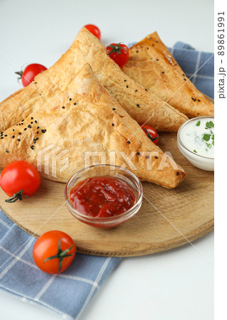 Concept of tasty food with samsa on white background Concept of tasty food with samsa on white background 89861991
