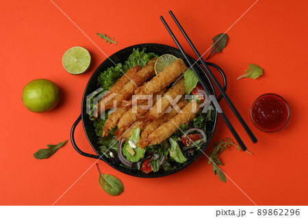Concept of tasty food with deep-fried shrimp on orange background Concept of tasty food with deep-fried shrimp on orange background 89862296