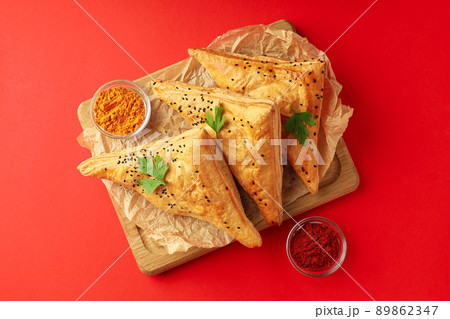 Concept of tasty food with samsa on red background 89862347