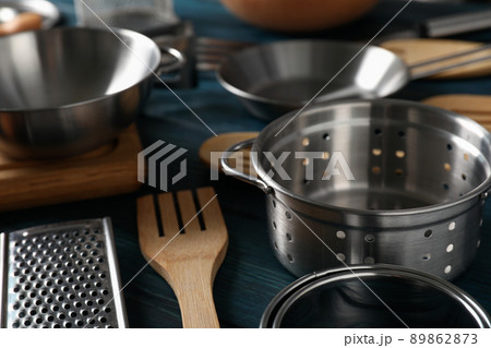 Different kitchen utensil on blue wooden background 89862873