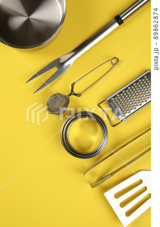 Kitchen utensil on yellow background, space for text Kitchen utensil on yellow background, space for text 89862874