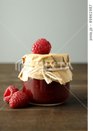 Jar of raspberry jam with ingredients on wooden background Jar of raspberry jam with ingredients on wooden background 89862987