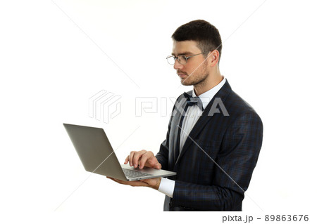 Businessman with laptop isolated on white background Businessman with laptop isolated on white background 89863676