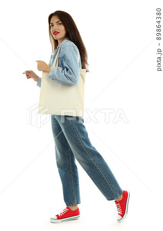 Attractive girl with cotton bag isolated on white background Attractive girl with cotton bag isolated on white background 89864380