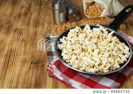 Concept of homemade popcorn on wooden background Concept of homemade popcorn on wooden background 89864756
