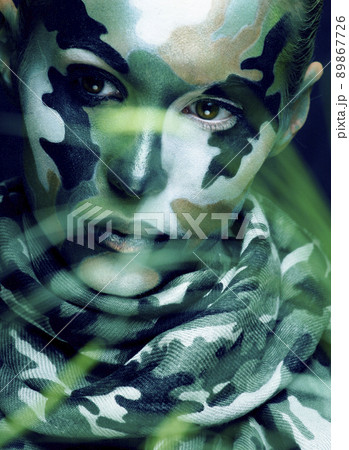 Beautiful young fashion woman with military style clothing and face paint make-up, khaki colors, halloween celebration closeup 89867726