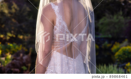 White Caucasian Adult Woman in a Wedding Dress standing outside in nature 89868461