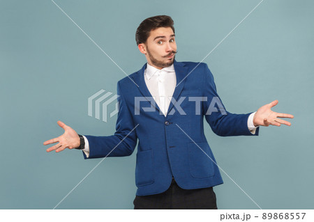 I don't now. Portrait of confused man. Business people concept, richly and success. Indoor, studio shot on light blue background I don't now. Portrait of confused man. Business people concept, richly and success. Indoor, studio shot on light blue background 89868557