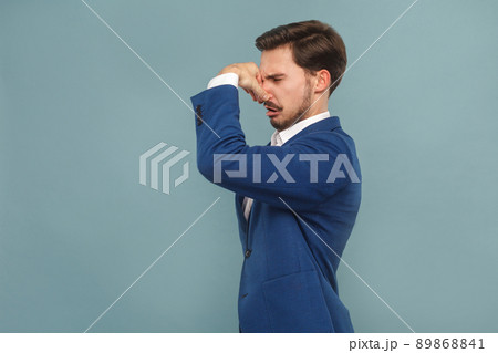 fu, what is bad smell? Unhappy man closed nose hand. Business people concept, richly and success. Indoor, studio shot on light blue background 89868841