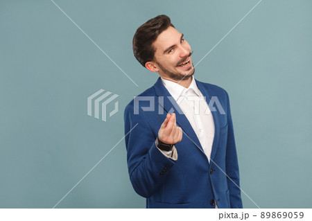 Give me money. Foxy businessman toothy smiling . Business people concept, richly and success. Indoor, studio shot on light blue background Give me money. Foxy businessman toothy smiling . Business people concept, richly and success. Indoor, studio shot on light blue background 89869059