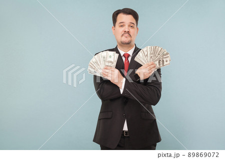 Portrait of cool wealthy successful businessman. Indoor, studio shot, isolated on light blue or gray background 89869072