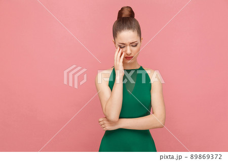 Portrait of unhappy sadness woman with collected hair cry. Expression emotion and feelings concept. Studio shot, isolated on pink background Portrait of unhappy sadness woman with collected hair cry. Expression emotion and feelings concept. Studio shot, isolated on pink background 89869372