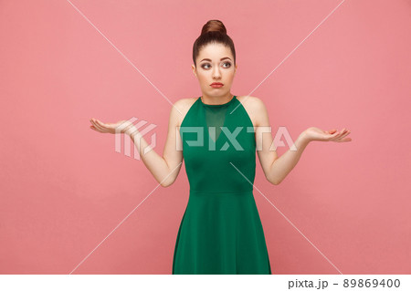 I don't know. Portrait of cute puzzled woman. Expression emotion and feelings concept. Studio shot, isolated on pink background I don't know. Portrait of cute puzzled woman. Expression emotion and feelings concept. Studio shot, isolated on pink background 89869400