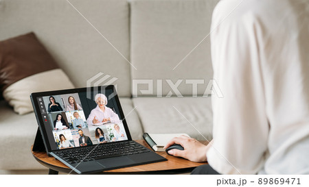 Web meeting. Group video chat. Internet communication. Business woman working from home using tablet cooperating online with team on screen in virtual office with free space. 89869471