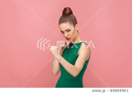 Aggressive woman boxing. Expression emotion and feelings concept. Studio shot, isolated on pink background Aggressive woman boxing. Expression emotion and feelings concept. Studio shot, isolated on pink background 89869961