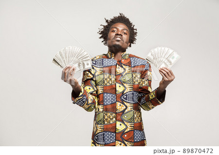 Success and richly african businessman or mafia boss. Indoor, isolated on gray background Success and richly african businessman or mafia boss. Indoor, isolated on gray background 89870472