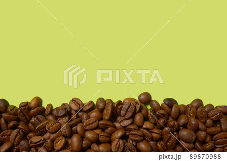 Texture of coffee beans. Roasted coffee beans background. close up Coffee beans with copy space on green background 89870988