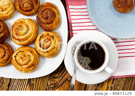 breakfast in the village fresh rolls, coffee, berries and honey laid out on an old brown wooden table. 89871129