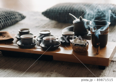 Preparing for a tea ceremony with a large company Preparing for a tea ceremony with a large company 89871515