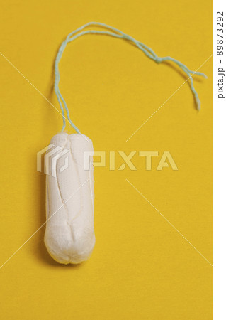 Hygienic tampons on yellow background, women's healthy. 89873292