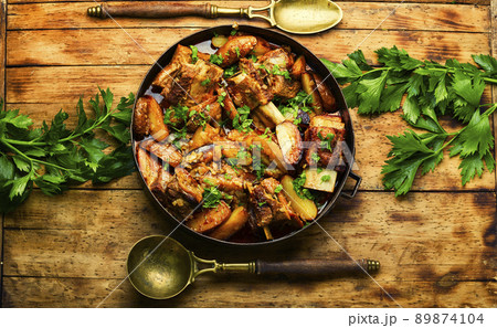 Delicious beef ribs with baked potatoes. Delicious beef ribs with baked potatoes. 89874104