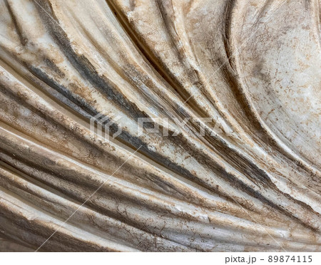 ancient texture. beige stone, voluminous background. a statue in robes, a piece of marble cloth. rusty white background 89874115