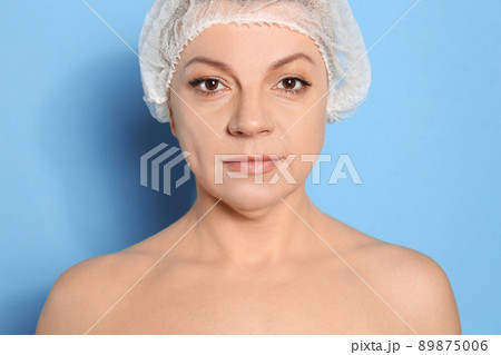 Mature woman with double chin on blue background 89875006