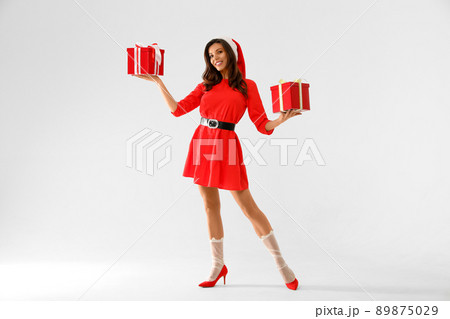 Beautiful woman wearing Christmas costume with gifts on white background 89875029