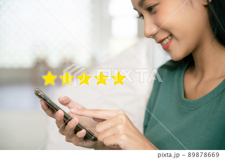Woman hand using smart phone with icon five star symbol to increase rating of company concept 89878669