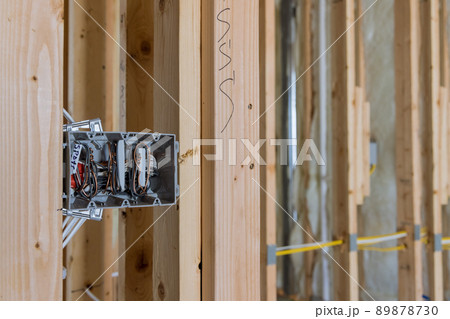 Electrician routing wires in electric plug connector electric sockets on the wall Electrician routing wires in electric plug connector electric sockets on the wall 89878730