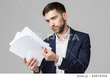 Business Concept - Portrait Handsome Business man serious working with annual report. White Background. Copy Space. 89879408