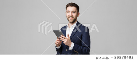 Business Concept - Portrait Handsome Business man playing digital tablet with smiling confident face. White Background. Copy Space. Business Concept - Portrait Handsome Business man playing digital tablet with smiling confident face. White Background. Copy Space. 89879493