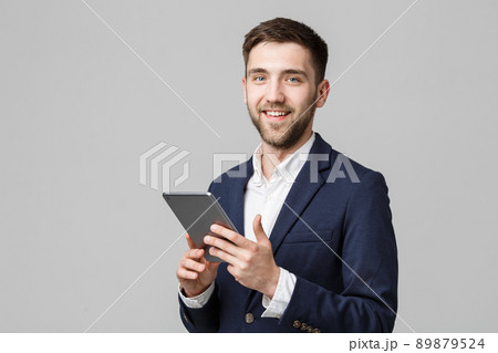 Business Concept - Portrait Handsome Business man playing digital tablet with smiling confident face. White Background. Copy Space. 89879524