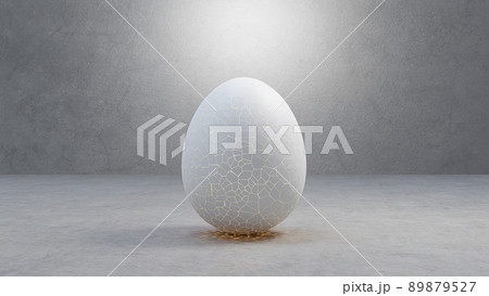 Cracked egg to hatching with light inside, on cement floor, and light shining from above. 89879527